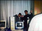 Some computers at the System Shock BBS booth; on the left Bernardo Innocenti. Click to enlarge