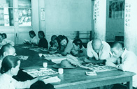 In the early 1950s,  classes were set up for the Chinese to learn to write and read in many places. Here, peasants doing reading in a cultural hall. 