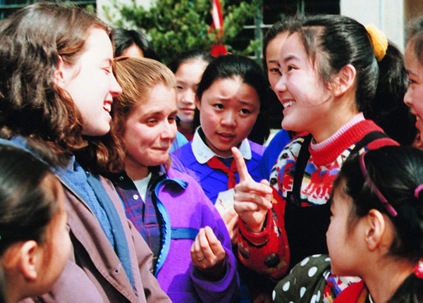 Foreign language is one of the compulsory cources for middle school students to take. Picture shows some students practicing oral English with foreigners.